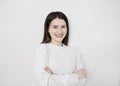 Portrait of young beautiful cute cheerful girl smiling looking at camera over white background. Royalty Free Stock Photo