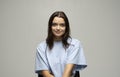 Portrait of young beautiful cute cheerful girl woman in beige t-shirt smiling looking at camera over blue background. Royalty Free Stock Photo