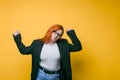 Young redhead woman doing selfie in studio