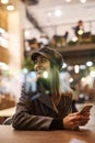 Portrait of young beautiful fashionable brunette woman sitting in coffeehouse Royalty Free Stock Photo