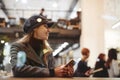 Portrait of young beautiful fashionable brunette woman sitting in coffeehouse Royalty Free Stock Photo