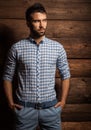 Portrait of young beautiful fashionable man against wooden wall. Royalty Free Stock Photo