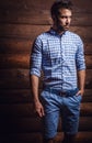 Portrait of young beautiful fashionable man against wooden wall. Royalty Free Stock Photo