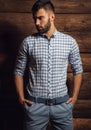 Portrait of young beautiful fashionable man against wooden wall. Royalty Free Stock Photo