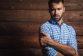 Portrait of young beautiful fashionable man against wooden wall. Royalty Free Stock Photo