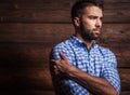 Portrait of young beautiful fashionable man against wooden wall. Royalty Free Stock Photo