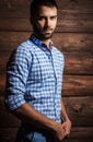 Portrait of young beautiful fashionable man against wooden wall. Royalty Free Stock Photo