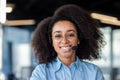 Portrait of young beautiful female online customer support worker, business woman smiling and looking at camera, with Royalty Free Stock Photo