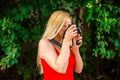 portrait young beautiful female photographer with camera in nature Royalty Free Stock Photo