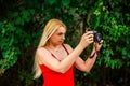 portrait young beautiful female photographer with camera in nature Royalty Free Stock Photo