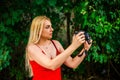 portrait young beautiful female photographer with camera in nature Royalty Free Stock Photo