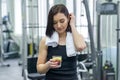 Portrait of young beautiful fitness woman in sportswear with towel, with glass of water and lemon, after fitness classes drinking Royalty Free Stock Photo