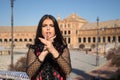 Portrait of young, beautiful and flamenco woman, Hispanic and brunette, with typical dance suit, playing palms. Concept of