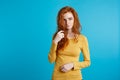 Portrait of young beautiful ginger woman confident looking at camera. Isolated on pastel blue background. Copy space. Royalty Free Stock Photo