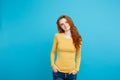 Portrait of young beautiful ginger woman with freckles cheerfuly smiling looking at camera. Isolated on pastel blue Royalty Free Stock Photo