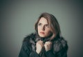 Portrait of a young beautiful girl in a black fur coat Royalty Free Stock Photo