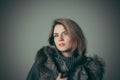 Portrait of a young beautiful girl in a black fur coat Royalty Free Stock Photo