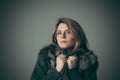 Portrait of a young beautiful girl in a black fur coat Royalty Free Stock Photo