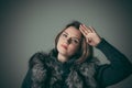 Portrait of a young beautiful girl in a black fur coat Royalty Free Stock Photo