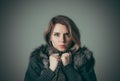 Portrait of a young beautiful girl in a black fur coat Royalty Free Stock Photo