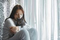 portrait of a young beautiful girl with a cat near the window