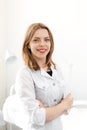 Portrait of a young beautiful girl cosmetologist doctor in a white coat in a white office Royalty Free Stock Photo