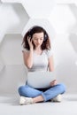 Portrait of a young beautiful girl with curly hair eyes closed with headphones listening to music and working with laptop Royalty Free Stock Photo