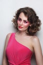 Beautiful girl with curly hair and hot pink disco makeup