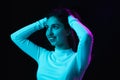 Portrait of young beautiful girl  on dark background in neon light Royalty Free Stock Photo