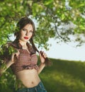 Portrait of a young beautiful girl dressed in country style, wit