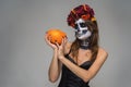 Portrait of young beautiful girl with fearful halloween skeleton makeup with a wreath Katrina Calavera made of flowers on her head Royalty Free Stock Photo