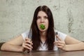 Portrait of a young, beautiful girl holding a broccoli in her mouth.. The concept of a healthy diet, detox, weight loss, diet,