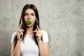 Portrait of a young, beautiful girl holding a broccoli in her mouth.. The concept of a healthy diet, detox, weight loss, diet, Royalty Free Stock Photo