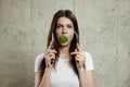 Portrait of a young, beautiful girl holding a broccoli in her mouth.. The concept of a healthy diet, detox, weight loss, diet, Royalty Free Stock Photo