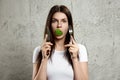 Portrait of a young, beautiful girl holding a broccoli in her mouth.. The concept of a healthy diet, detox, weight loss, diet, Royalty Free Stock Photo