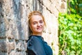 Portrait of a young and beautiful girl near a brick wall. Royalty Free Stock Photo