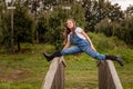 portrait of a young beautiful girl posing on the old wood bridge in green autumn farm Royalty Free Stock Photo