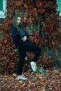 Portrait of a young beautiful girl with a smile on her face in an autumn park against a background of colorful leaves. A girl with Royalty Free Stock Photo