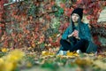 Portrait of a young beautiful girl with a smile on her face in an autumn park against a background of colorful leaves. A girl with Royalty Free Stock Photo