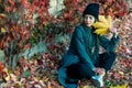 Portrait of a young beautiful girl with a smile on her face in an autumn park against a background of colorful leaves. A girl with Royalty Free Stock Photo