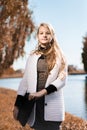 Portrait of young beautiful girl. teenager stands with laptop on the nature near the lake. toned. vertical frame Royalty Free Stock Photo