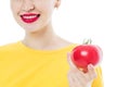 Portrait of a young, beautiful, girl with a tomato in her hands. Royalty Free Stock Photo