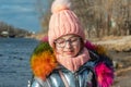 Portrait of young beautiful girl in winter style. Girl in glasses and a pink hat in winter Royalty Free Stock Photo