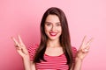 Portrait of young beautiful good mood positive lovely charming girl showing v-sign isolated on pink color background