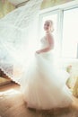 Portrait of young beautiful happy bride standing near a window Royalty Free Stock Photo