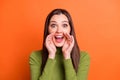 Portrait of young beautiful happy excited shocked girl hold hand mouth scream shout isolated on orange color background Royalty Free Stock Photo