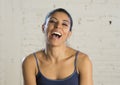 Portrait of young beautiful and happy hispanic woman wearing sport tank top laughing Royalty Free Stock Photo