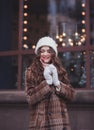 Portrait of a young beautiful happy smiling girl holding an icicle Royalty Free Stock Photo