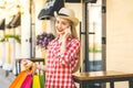 Portrait of young happy smiling woman with phone. Young woman holding shopping bags. Online shopping concept Royalty Free Stock Photo