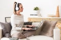 Woman listening music in headphones from her laptop Royalty Free Stock Photo